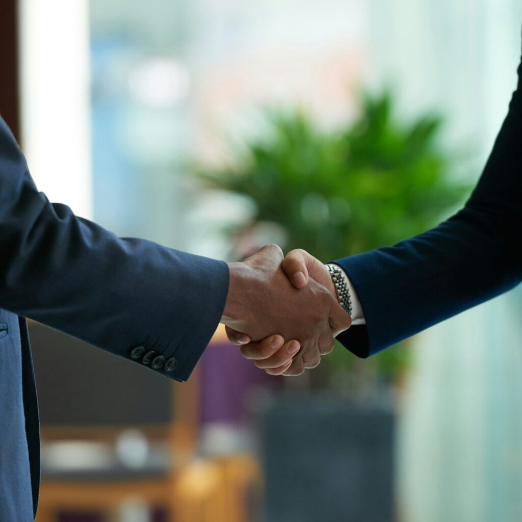 a close-up of a man and woman shaking hands